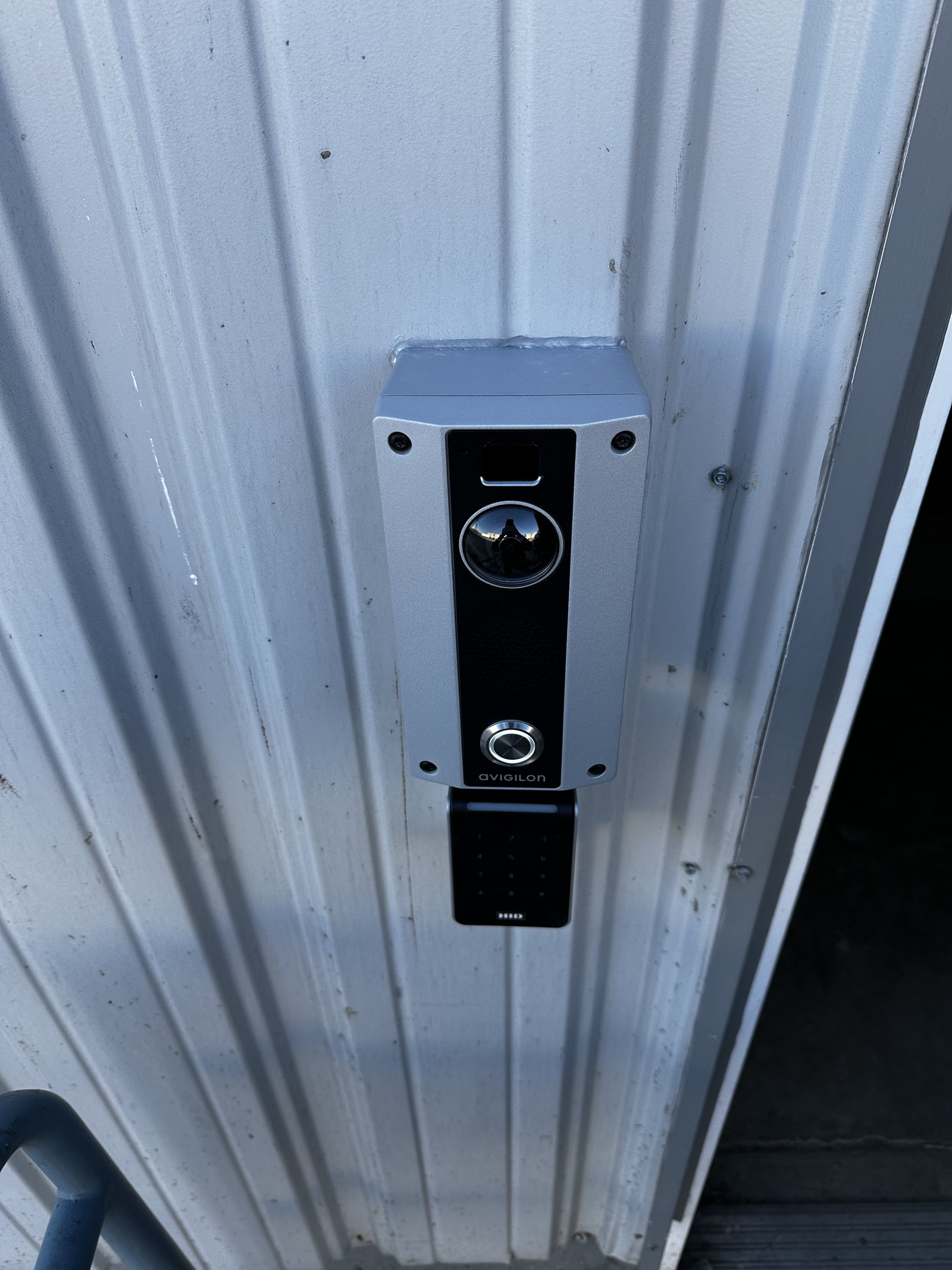 Avigilon video door intercom with HID keypad entry reader at a commercial building entrance