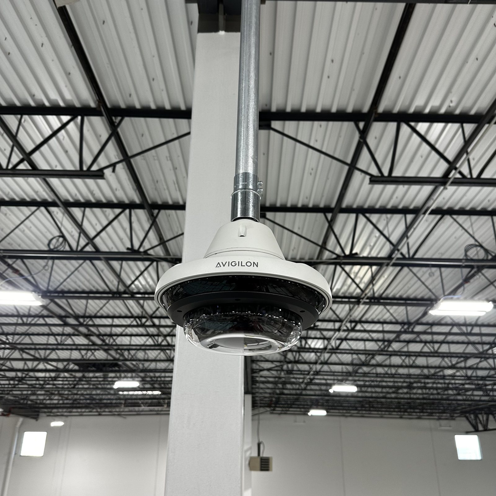 Avigilon multi-sensor dome camera mounted from a commercial warehouse ceiling