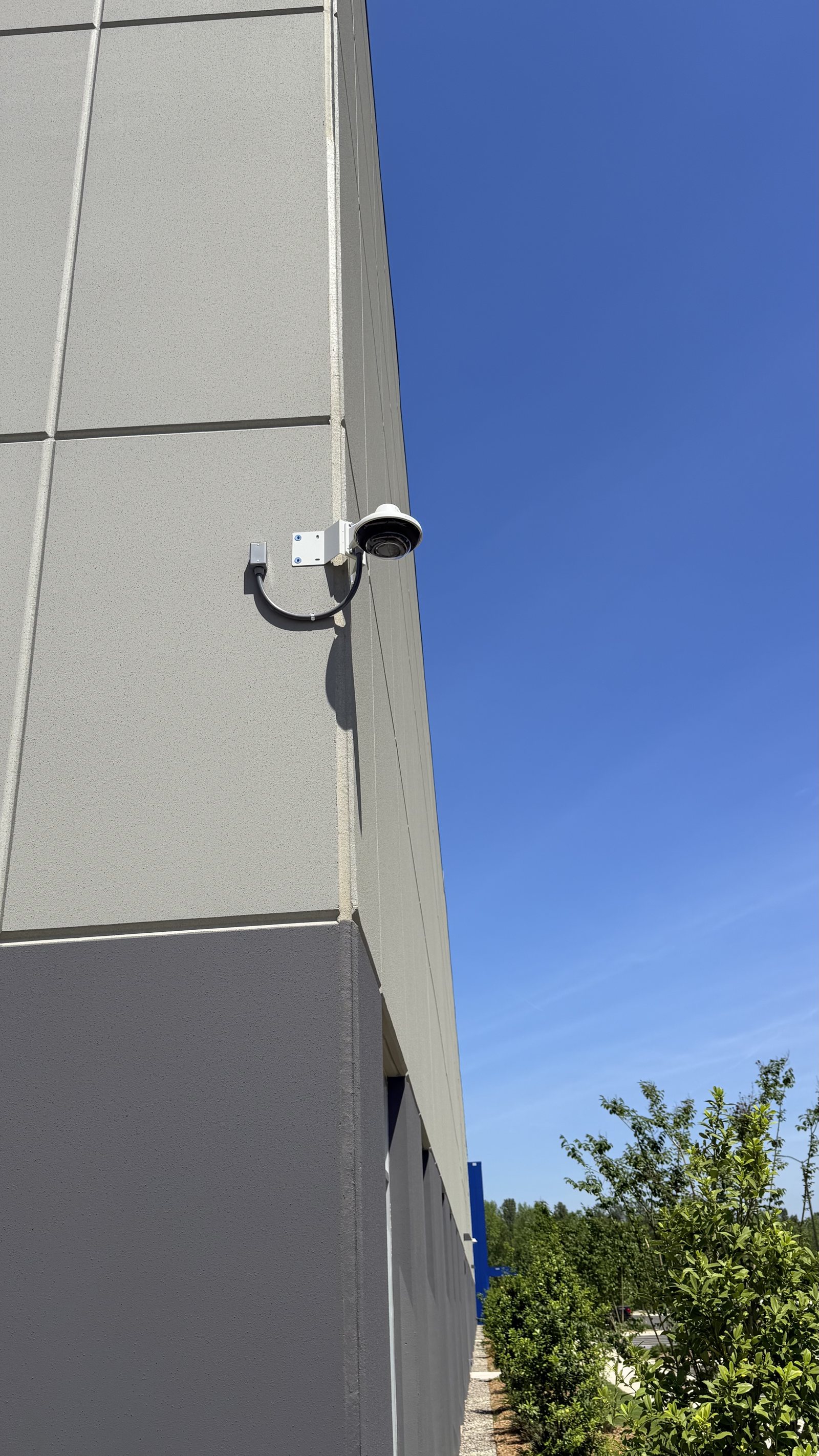 Exterior Avigilon bullet camera mounted on the corner of a commercial building